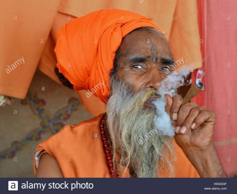 old-sadhu-with-dread-bun-and-orange-headwrap-smoking-hashish-marijuana-K9GGGF.jp.jpeg